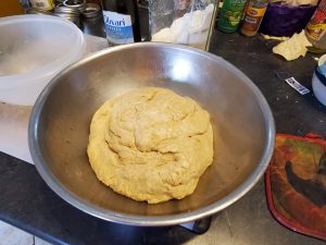 ball of bread dough in tin bowl