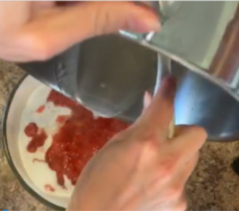 pouring water on strawberries