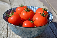 grey bowl with red tomatoes