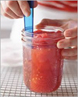 a canned jar of tomatoes with a ruler showing appropriate headspace