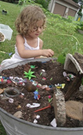 blonde girl planting flower bulbs in dirt