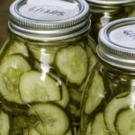 three canning jars of sliced pickles
